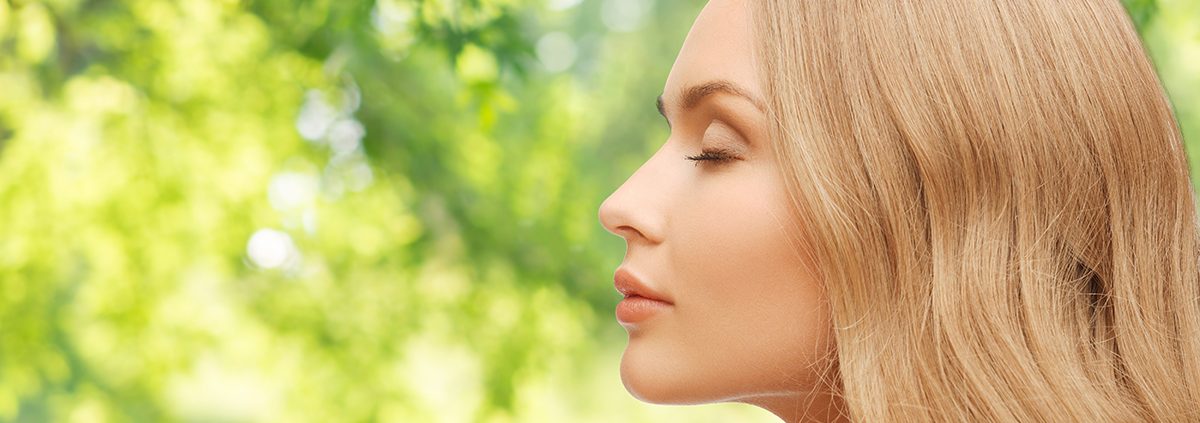 beautiful young woman face over natural background