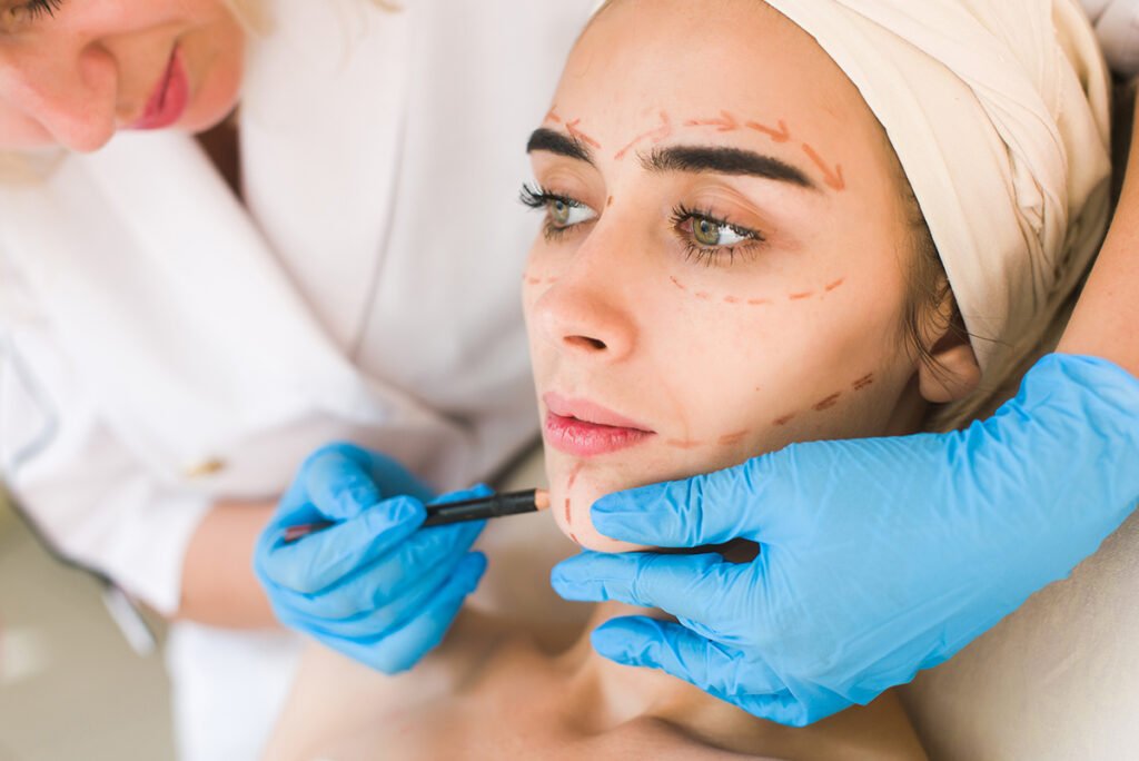 Doctor drawing marks on female face